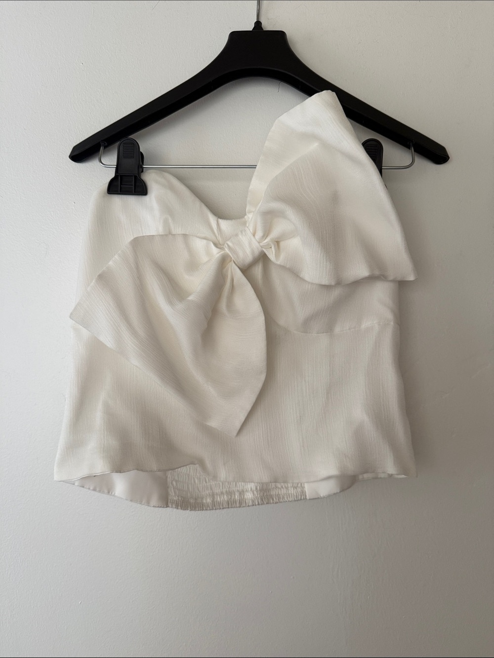 White satin top with large bow detail